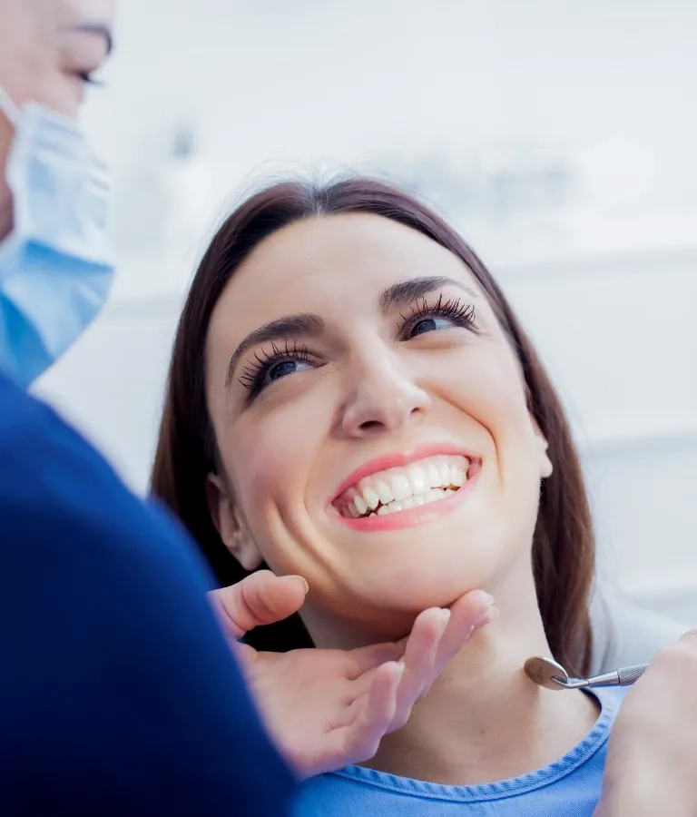 Chirurgia stomatologiczna uśmiechnięta kobieta u dentysty